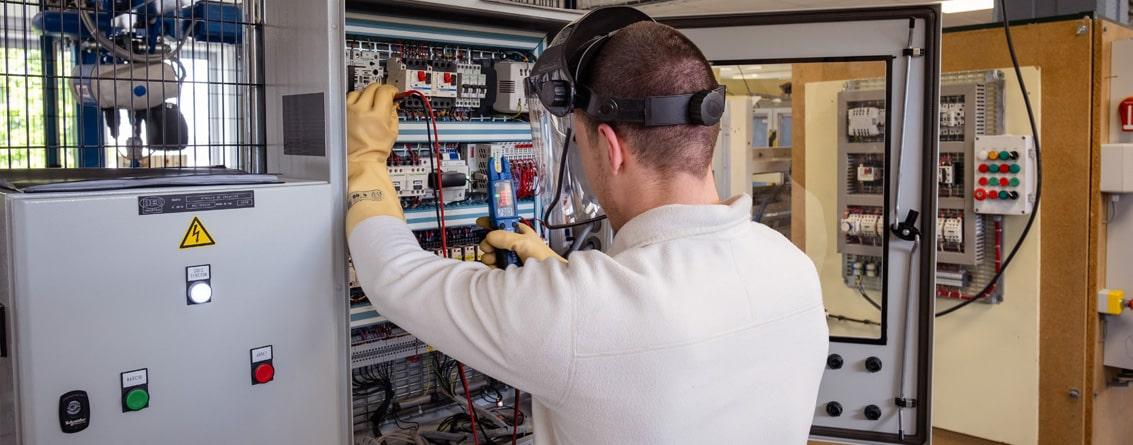 Apprenti travaillant dans une armoire électrique