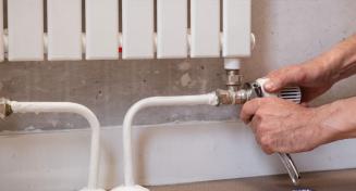 Homme en train de monter un radiateur à eau